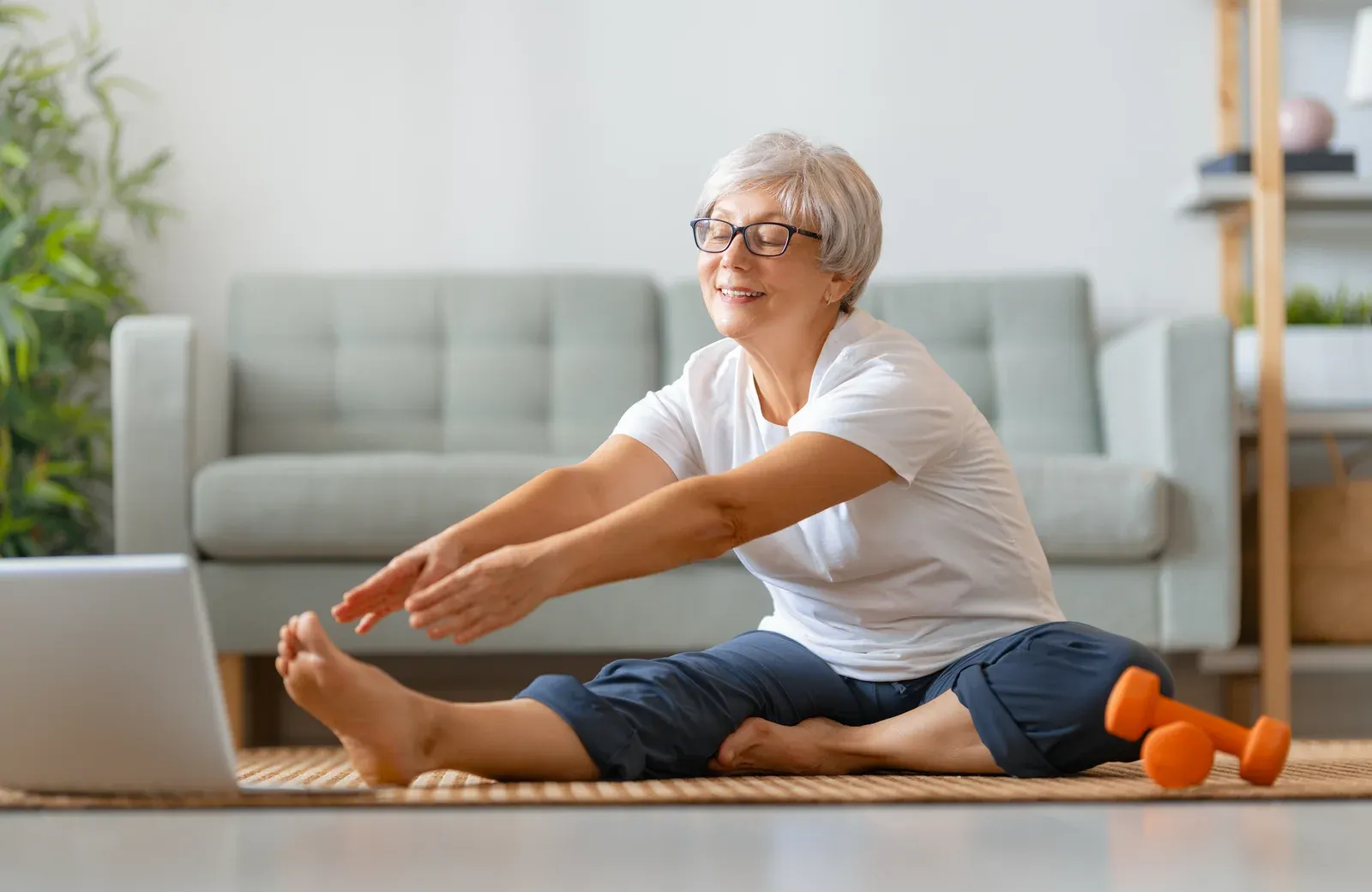 A seated range-of-motion movement on a mat